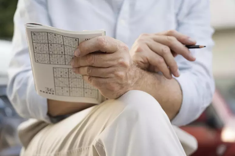 man-enjoying-sudoku-game-paper-1jenrlfi1rvp0